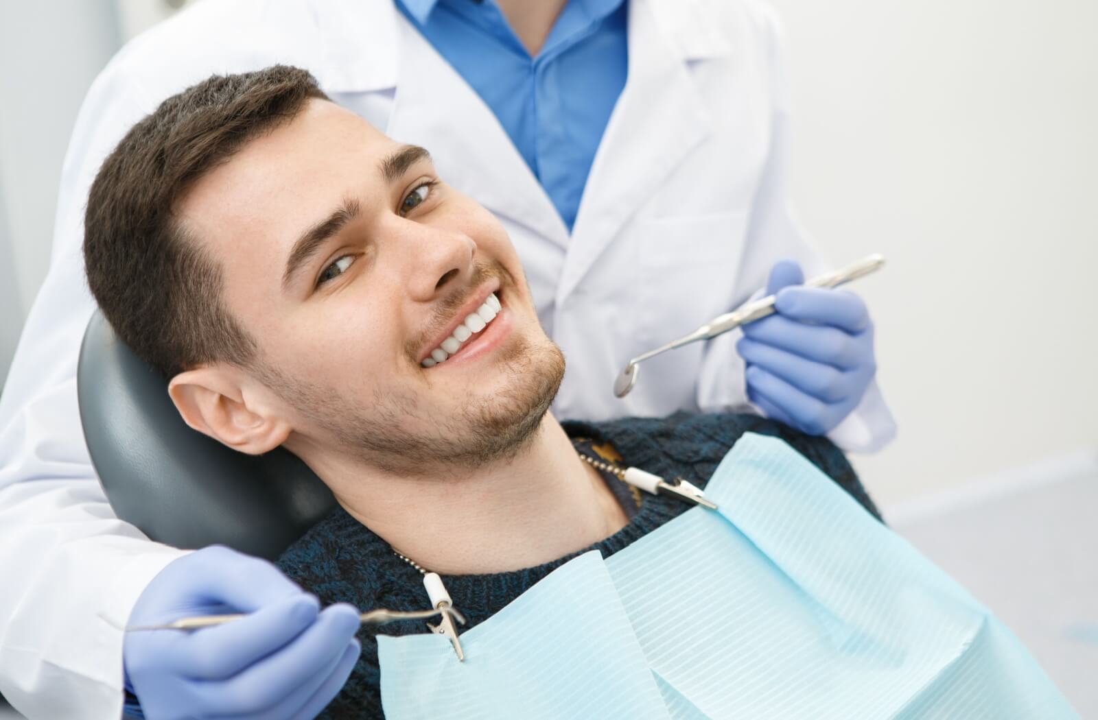 A person smiles for their first photo with their newly restored smile.